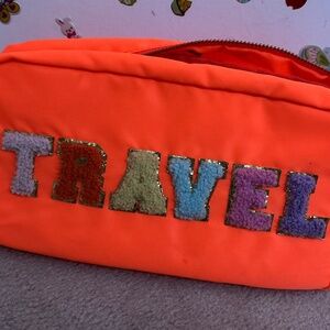 bright orange makeup bag